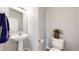 This powder room offers a pedestal sink and a decorative plant atop the toilet tank at 17926 E 104Th Way # C, Commerce City, CO 80022