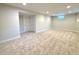 Finished basement with neutral carpeting and recessed lighting at 8239 Nola Dr, Denver, CO 80221