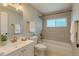 Clean, neutral bathroom with tiled shower-tub, and vanity with chrome hardware at 8239 Nola Dr, Denver, CO 80221