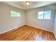Cozy bedroom with hardwood floors and natural light from two windows at 8239 Nola Dr, Denver, CO 80221