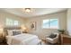 Cozy bedroom with two windows providing natural light and a sitting chair at 8239 Nola Dr, Denver, CO 80221