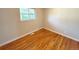 Bedroom with hardwood floors and natural light from a single window at 8239 Nola Dr, Denver, CO 80221