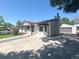 Well-maintained home with a detached garage, long driveway, and mature trees in the yard at 8239 Nola Dr, Denver, CO 80221