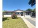 Charming single-story home featuring a manicured lawn, brick facade, and inviting front porch at 8239 Nola Dr, Denver, CO 80221