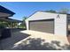 Detached garage with a large door, providing ample parking and storage at 8239 Nola Dr, Denver, CO 80221
