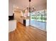 Bright kitchen with stainless steel appliances, white cabinets, and sliding glass doors to the backyard at 8239 Nola Dr, Denver, CO 80221