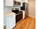 Efficient kitchen with stainless steel appliances, white cabinets, and light countertops at 8239 Nola Dr, Denver, CO 80221