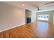 Bright living room with hardwood floors, a modern fireplace, and a large window at 8239 Nola Dr, Denver, CO 80221