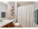 Cozy bathroom featuring neutral colors, decorative wall art, and a shower with curtain at 424 Wright St # 102, Lakewood, CO 80228