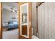 Bright bathroom featuring a large mirror, neutral shower curtain, and a glimpse into a cozy bedroom at 424 Wright St # 102, Lakewood, CO 80228