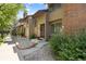 Charming townhome exterior with brick accents, stone landscaping, and inviting entry at 424 Wright St # 102, Lakewood, CO 80228