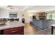 Open-concept living room with stone fireplace and hardwood floors at 424 Wright St # 102, Lakewood, CO 80228