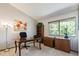 Bright home office featuring a wooden desk, bookshelf, and large window at 424 Wright St # 102, Lakewood, CO 80228
