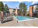Community swimming pool with lounge chairs at 424 Wright St # 102, Lakewood, CO 80228