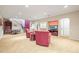 Basement recreation room featuring carpet, a staircase, a storage cabinet, and a TV at 6700 W Dorado Dr # 51, Littleton, CO 80123