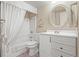 Bathroom with shower-tub combo, white vanity, round mirror and neutral walls at 6700 W Dorado Dr # 51, Littleton, CO 80123