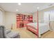 Bedroom with full bookcase, natural light from the window, and queen size bed at 6700 W Dorado Dr # 51, Littleton, CO 80123