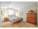 Bedroom featuring a bed with decorative pillows, two side tables with lamps and dresser at 6700 W Dorado Dr # 51, Littleton, CO 80123