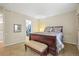 Bedroom featuring upholstered bench, a mirror into the closet, and side table with lamp at 6700 W Dorado Dr # 51, Littleton, CO 80123