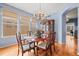 Formal dining room with a wooden table, chandelier, and ample natural light from large windows at 6700 W Dorado Dr # 51, Littleton, CO 80123