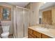 Bathroom featuring a glass shower enclosure, tile accents, and a vanity with a sink and wood-finished cabinets at 26367 Pressler St, Conifer, CO 80433