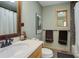 Bathroom with a wood-trimmed mirror and vanity, paired with neutral walls and fixtures at 26367 Pressler St, Conifer, CO 80433