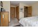 Bedroom featuring a light-colored interior, carpet, and wooden trim, leading to closet and another room at 26367 Pressler St, Conifer, CO 80433