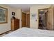 Bedroom with traditional-style furnishings and a view of an adjacent room through a wooden doorway at 26367 Pressler St, Conifer, CO 80433