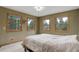 Bedroom boasting three windows that frame a view of the surrounding trees and nature at 26367 Pressler St, Conifer, CO 80433