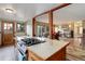 Kitchen featuring a breakfast bar and open floor plan leading to a cozy living area at 26367 Pressler St, Conifer, CO 80433