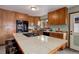 Spacious kitchen featuring custom wood cabinetry, a central island cooktop, and modern appliances at 26367 Pressler St, Conifer, CO 80433