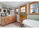 Cozy kitchen nook with wood cabinets, tile floor, warm lighting, and charming decor at 26367 Pressler St, Conifer, CO 80433