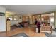 Inviting living area with wood floors, comfortable seating, and an open view to the kitchen at 26367 Pressler St, Conifer, CO 80433