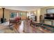Spacious living room with hardwood floors, wood-burning fireplace, and natural lighting at 26367 Pressler St, Conifer, CO 80433