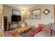 Comfortable living room with ample seating, entertainment center, and bright windows at 26367 Pressler St, Conifer, CO 80433
