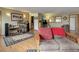 Open living area with wood floors, comfortable seating, and a seamless flow to other rooms at 26367 Pressler St, Conifer, CO 80433