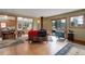Bright living room featuring hardwood floors, wood-burning stove, and seamless transition to the kitchen at 26367 Pressler St, Conifer, CO 80433