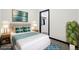 Staged bedroom features a queen bed, nightstands, and a closet at 1601 Park Ave # 106, Denver, CO 80218
