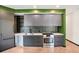 Sleek kitchen with gray cabinets, stainless steel appliances, and modern backsplash at 1601 Park Ave # 106, Denver, CO 80218