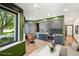 Modern kitchen with gray cabinets, stainless steel appliances, and adjacent dining area at 1601 Park Ave # 106, Denver, CO 80218