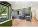Contemporary kitchen with gray cabinets, stainless steel appliances, and a large window at 1601 Park Ave # 106, Denver, CO 80218