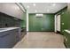 Modern kitchen features gray cabinets, subway tile backsplash, and concrete floors at 1601 Park Ave # 106, Denver, CO 80218