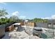 Stylish roof deck features an outdoor kitchen with grill, bar seating, and dining area for entertainment at 1601 Park Ave # 106, Denver, CO 80218