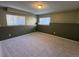 Finished basement room, neutral walls, carpet, and large windows at 1517 Stanley Dr, Erie, CO 80516