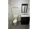 Modern bathroom with a glass shower, stylish vanity, and a contemporary mirror at 1517 Stanley Dr, Erie, CO 80516