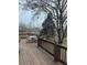 Relaxing wooden deck features outdoor dining furniture and beautiful views of the serene backyard at 1517 Stanley Dr, Erie, CO 80516