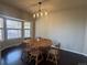 Bright dining room with wood table and a large window providing natural light and a view at 1517 Stanley Dr, Erie, CO 80516