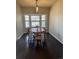 Charming dining area with a wooden table set, hardwood floors, and bright natural lighting at 1517 Stanley Dr, Erie, CO 80516