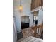 Open entryway with tile flooring leading to a dining area and living space, enhanced by a stylish overhead light fixture at 1517 Stanley Dr, Erie, CO 80516