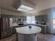 Updated kitchen with stainless steel appliances, tiled countertops, and a tile-topped island at 1517 Stanley Dr, Erie, CO 80516